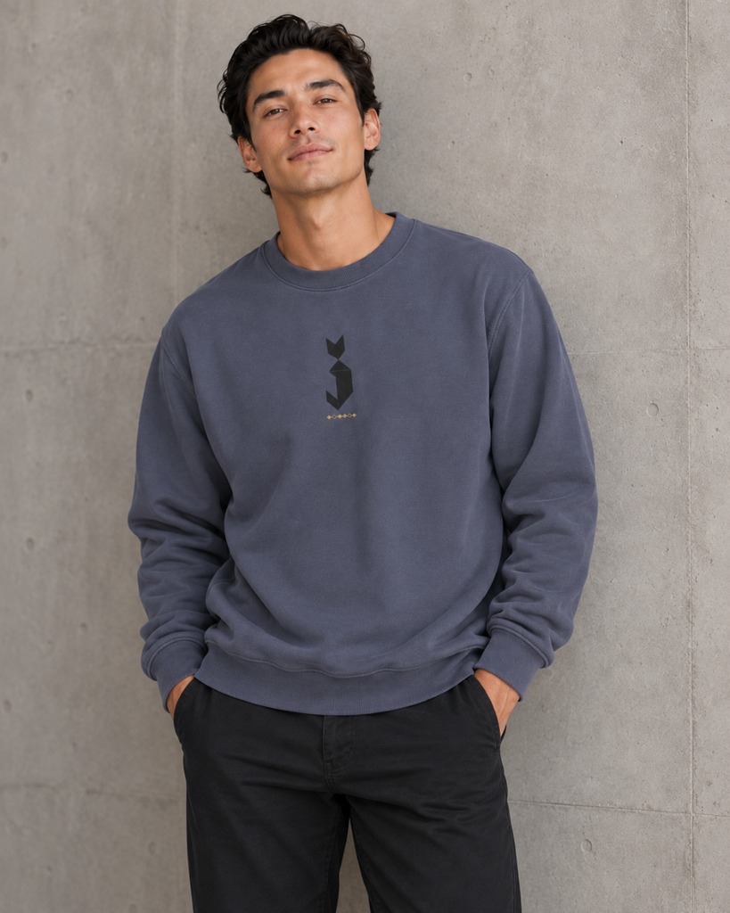 Geometric animal design on a dark blue sweatshirt worn by a male model